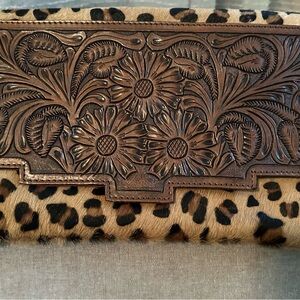 Leather/cowhide clutch purse w/strap.  Leather tassels.